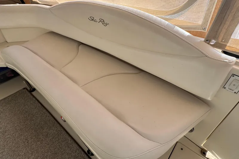 Solid Rock Yacht Photos Pics 2003 Sea Ray 380 Sundancer interior with beige seating and logo detail.