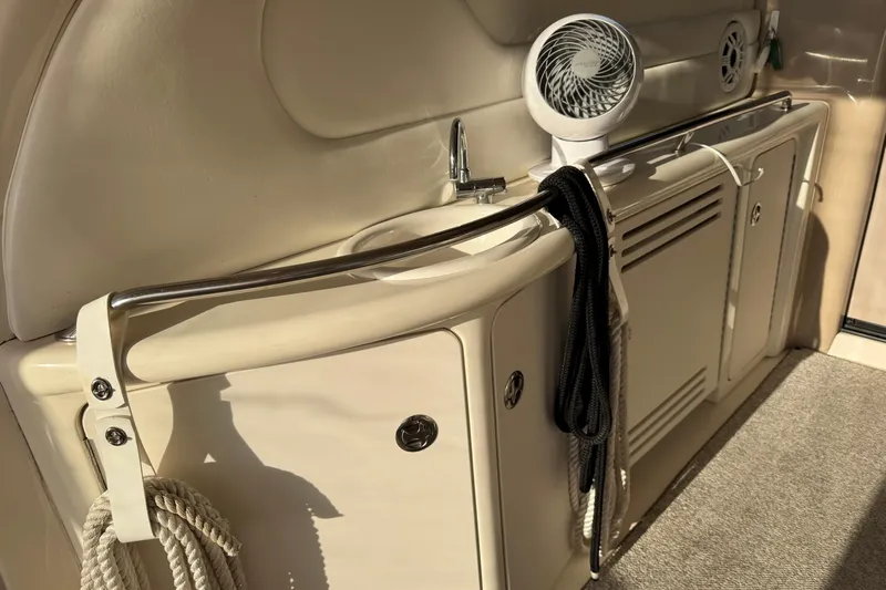 Solid Rock Yacht Photos Pics 2003 Sea Ray 380 Sundancer interior with sink, fan, and storage cabinets.