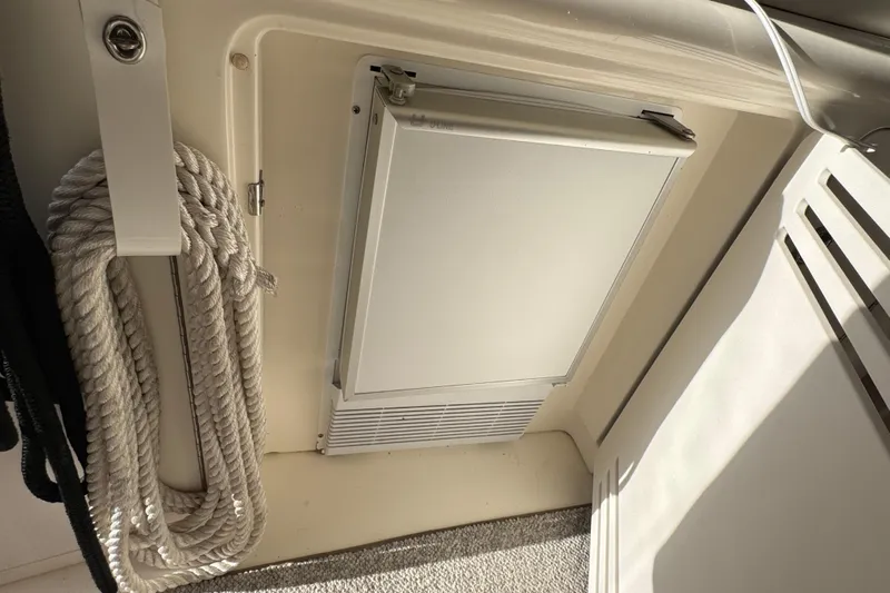 Solid Rock Yacht Photos Pics 2003 Sea Ray 380 Sundancer interior with coiled rope and storage compartment.