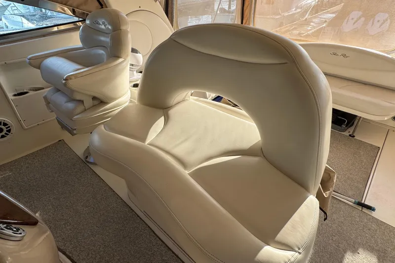 Solid Rock Yacht Photos Pics Luxurious interior seating of 2003 Sea Ray 380 Sundancer yacht, featuring plush cream upholstery.
