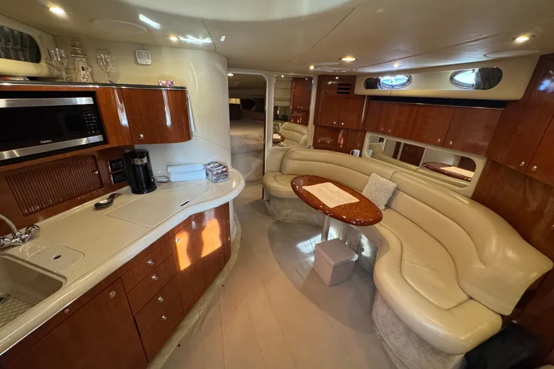 Solid Rock Yacht Photos Pics Luxurious interior of 2003 Sea Ray 380 Sundancer yacht with kitchen and seating area.