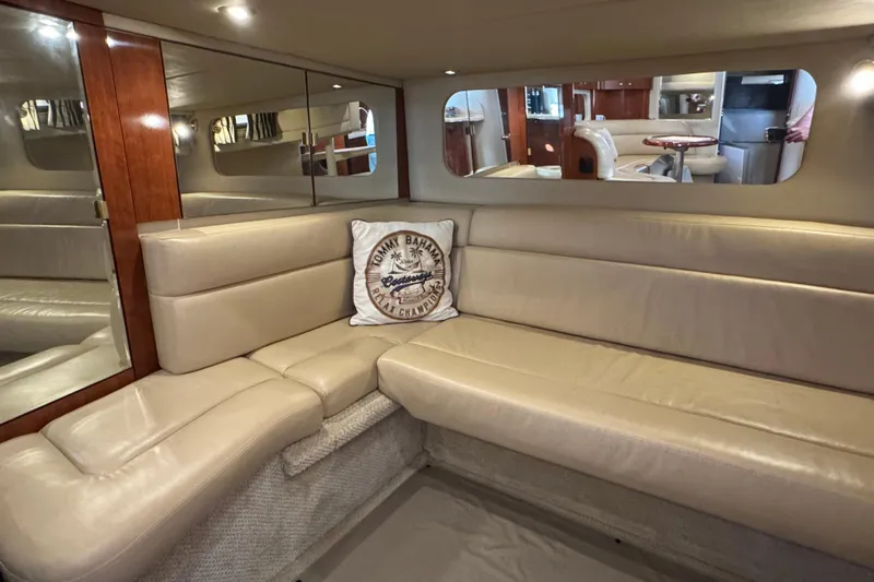 Solid Rock Yacht Photos Pics Luxurious interior of 2003 Sea Ray 380 Sundancer with beige leather seating and elegant wood accents.
