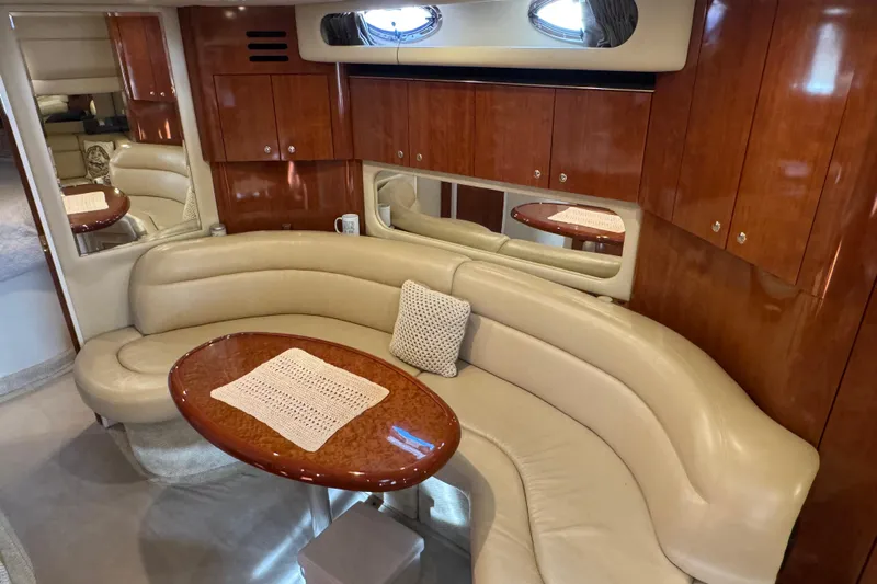 Solid Rock Yacht Photos Pics Luxurious interior of 2003 Sea Ray 380 Sundancer with leather seating and wooden cabinetry.