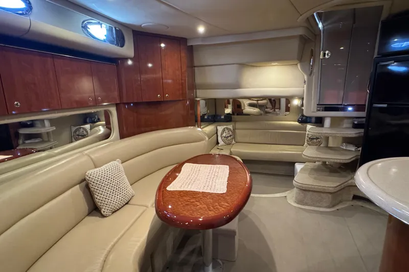 Solid Rock Yacht Photos Pics Luxurious interior of 2003 Sea Ray 380 Sundancer yacht with elegant seating and wooden cabinetry.
