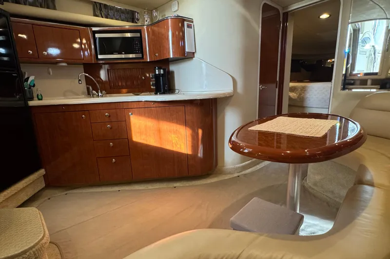Solid Rock Yacht Photos Pics Luxurious interior of 2003 Sea Ray 380 Sundancer yacht with kitchenette and dining area.