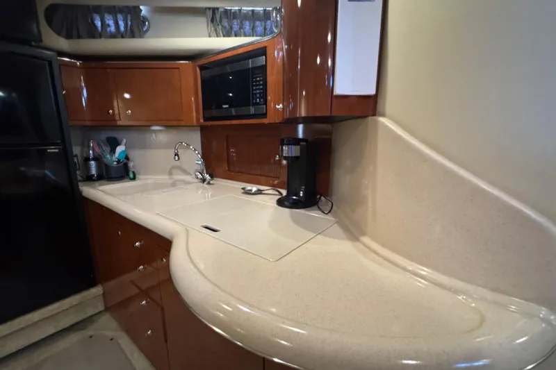 Solid Rock Yacht Photos Pics Luxurious kitchen area in a 2003 Sea Ray 380 Sundancer yacht with modern amenities.