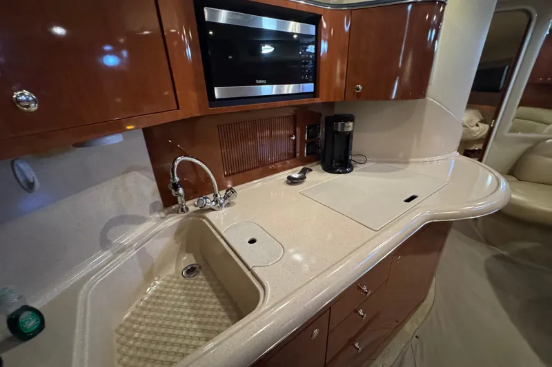 Solid Rock Yacht Photos Pics Luxurious 2003 Sea Ray 380 Sundancer yacht kitchen with modern amenities and sleek design.