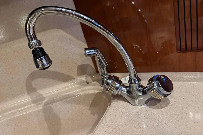 Solid Rock Yacht Photos Pics Chrome faucet in a 2003 Sea Ray 380 Sundancer yacht kitchen.
