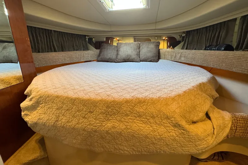 Solid Rock Yacht Photos Pics Cozy cabin interior of 2003 Sea Ray 380 Sundancer with comfortable bedding.