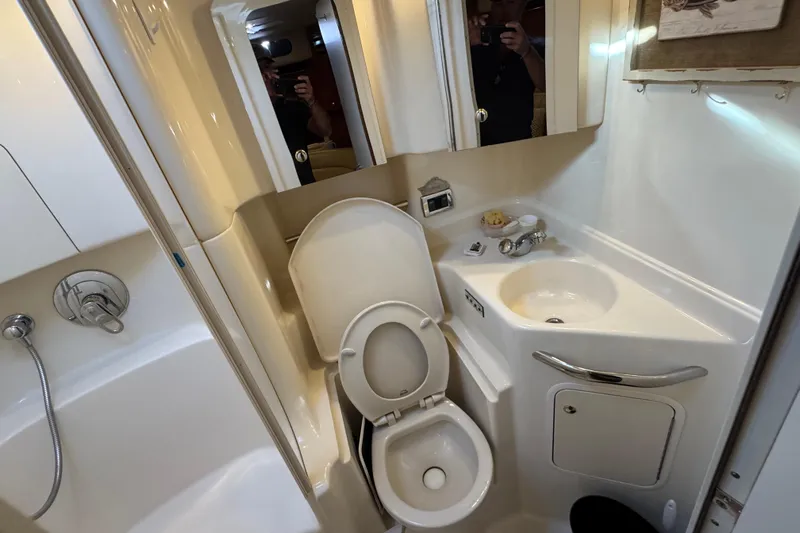 Solid Rock Yacht Photos Pics Bathroom interior of 2003 Sea Ray 380 Sundancer yacht, featuring toilet, sink, and shower.