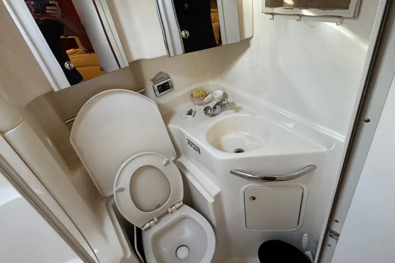 Solid Rock Yacht Photos Pics 2003 Sea Ray 380 Sundancer bathroom with toilet, sink, and mirror.
