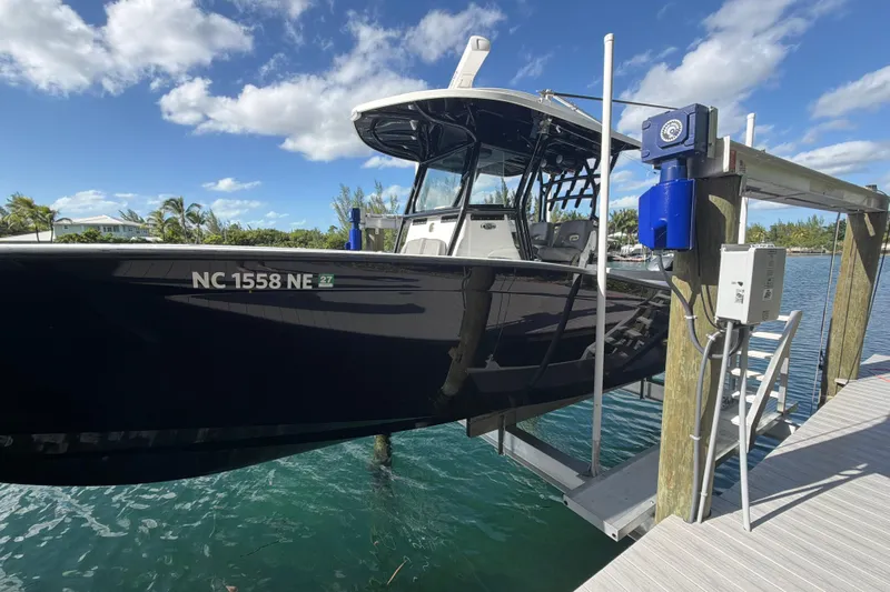  Yacht Photos Pics 2023 Cape Horn 32 XS boat docked, featuring sleek black design under a clear blue sky.