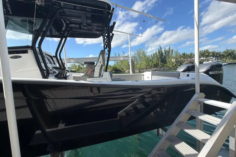  Yacht Photos Pics 2023 Cape Horn 32 XS boat docked, featuring sleek black hull and Suzuki engines.