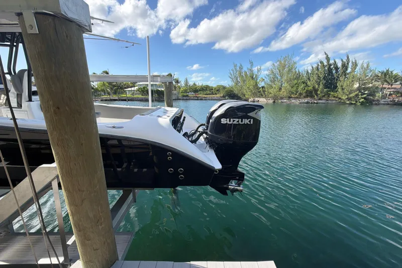  Yacht Photos Pics 2023 Cape Horn 32 XS boat with Suzuki outboard motor on a serene waterway.