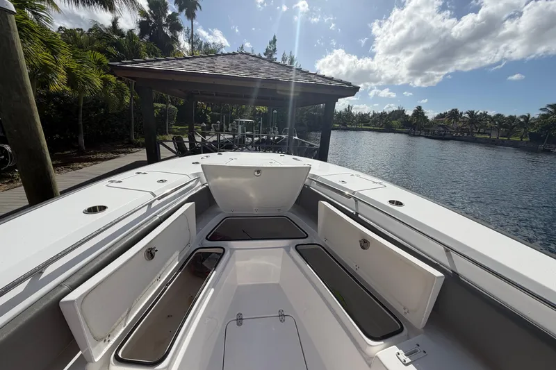  Yacht Photos Pics 2023 Cape Horn 32 XS boat with open storage compartments, docked by a scenic waterfront.