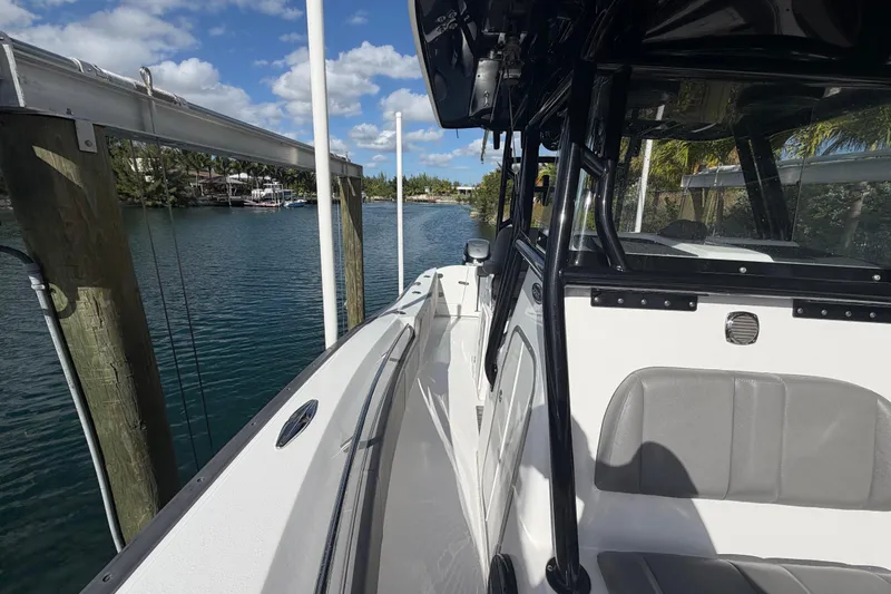 Yacht Photos Pics 2023 Cape Horn 32 XS boat docked by a scenic waterfront under a blue sky.