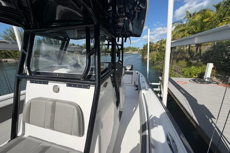  Yacht Photos Pics 2023 Cape Horn 32 XS boat docked by a scenic waterway with lush greenery.