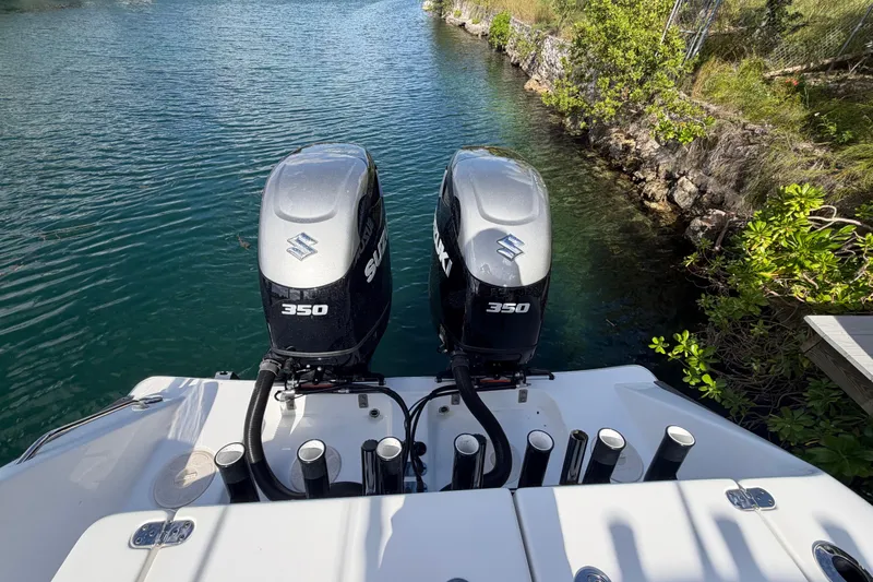  Yacht Photos Pics 2023 Cape Horn 32 XS boat with dual Suzuki 350 outboard engines on a calm waterway.