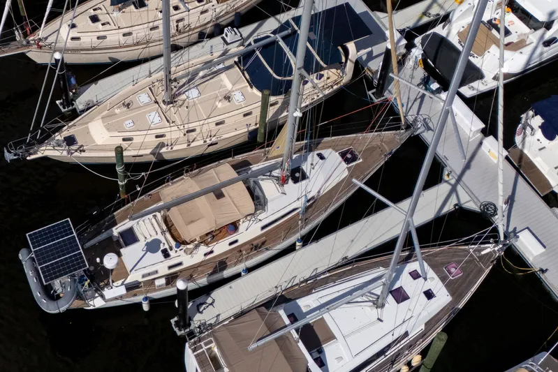 Pacific Pearl Yacht Photos Pics Overhead view of docked 1991 Oyster LW48 sailboats in a marina.