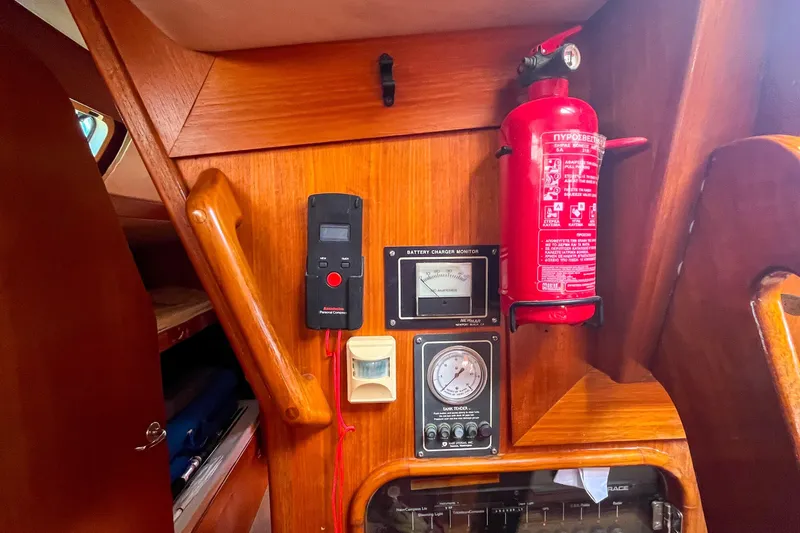 Pacific Pearl Yacht Photos Pics Interior of 1991 Oyster LW48 yacht with fire extinguisher and control panel.
