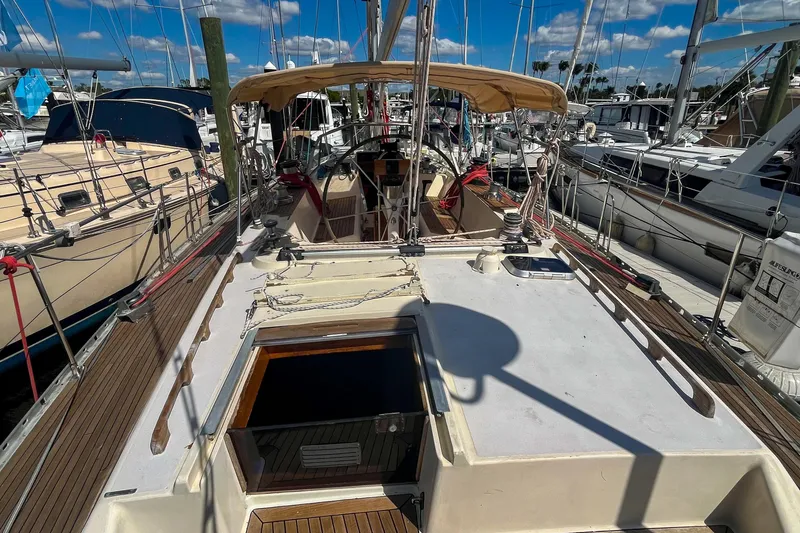Pacific Pearl Yacht Photos Pics 1991 Oyster LW48 sailboat docked at marina under clear blue sky.