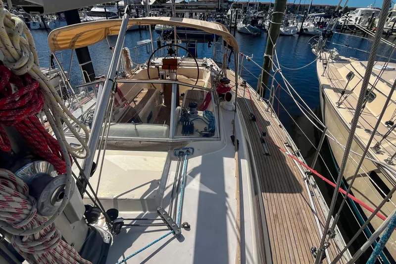 Pacific Pearl Yacht Photos Pics Sailboat deck view of 1991 Oyster LW48, docked in a marina with clear skies.