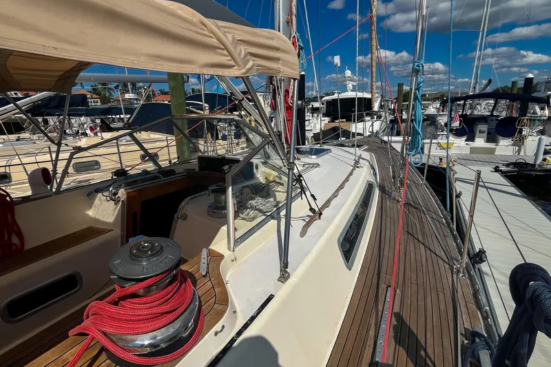 Pacific Pearl Yacht Photos Pics 1991 Oyster LW48 sailboat docked, featuring teak deck and rigging under a clear sky.