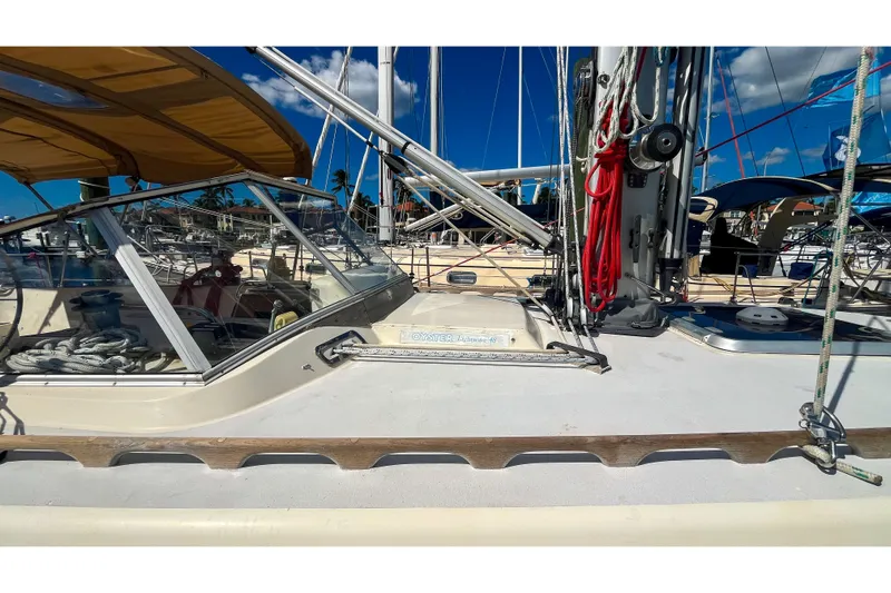 Pacific Pearl Yacht Photos Pics 1991 Oyster LW48 sailboat deck with rigging and cockpit, docked under clear blue sky.