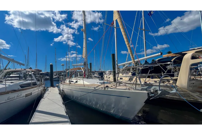 Pacific Pearl Yacht Photos Pics Sailboats docked at marina under blue sky, featuring 1991 Oyster LW48 model.