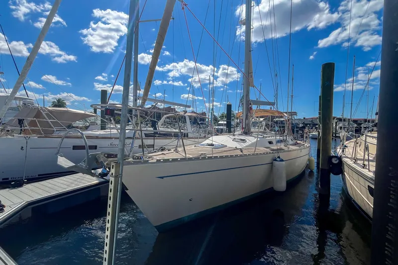 Pacific Pearl Yacht Photos Pics 1991 Oyster LW48 sailboat docked at marina under blue sky.