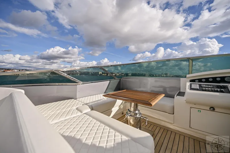  Yacht Photos Pics Luxurious 2007 Azimut 98 Leonardo yacht deck with seating and table under a cloudy sky.