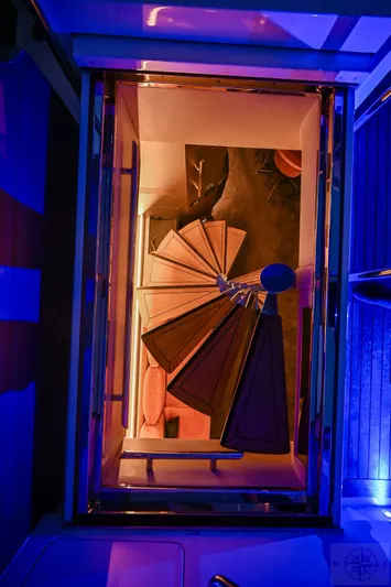  Yacht Photos Pics Spiral staircase on 2007 Azimut 98 Leonardo yacht, illuminated with vibrant blue and orange lighting.
