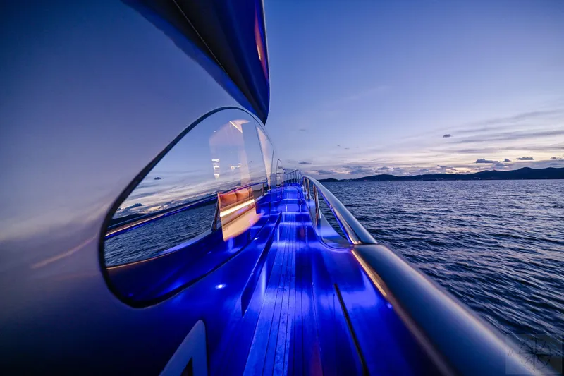  Yacht Photos Pics Azimut 98 Leonardo yacht, 2007 model, with blue deck lights at sunset on the ocean.