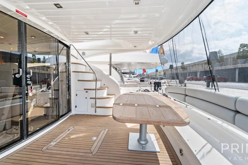  Yacht Photos Pics Luxurious 2008 Sunseeker Manhattan 70 yacht deck with elegant seating and wooden table.