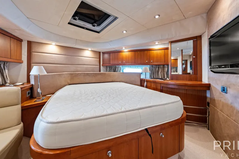  Yacht Photos Pics Luxurious bedroom interior of 2008 Sunseeker Manhattan 70 yacht with elegant wood finishes.