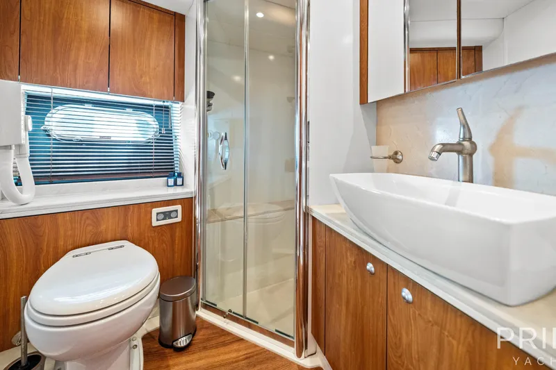  Yacht Photos Pics Luxurious bathroom on 2008 Sunseeker Manhattan 70 yacht with modern fixtures and wood accents.