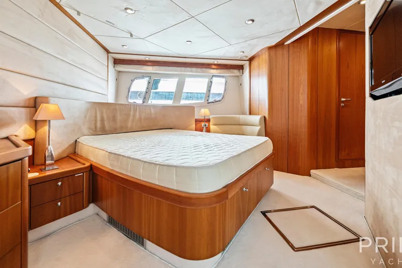  Yacht Photos Pics Luxurious bedroom interior of 2008 Sunseeker Manhattan 70 yacht with elegant wood finishes.
