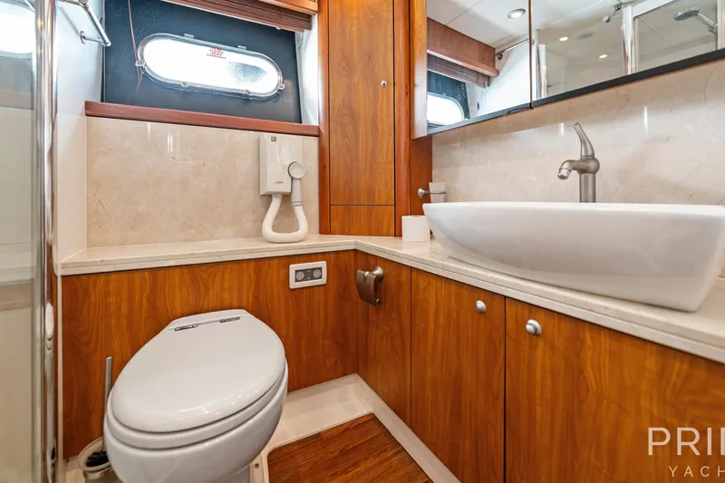  Yacht Photos Pics Luxurious bathroom in 2008 Sunseeker Manhattan 70 yacht with modern fixtures and wood cabinetry.