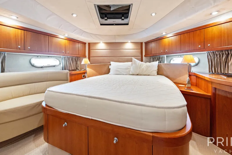  Yacht Photos Pics Luxurious bedroom interior of 2008 Sunseeker Manhattan 70 yacht with elegant wood finishes.