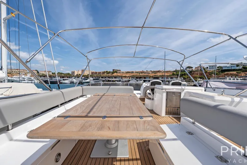  Yacht Photos Pics Luxurious 2008 Sunseeker Manhattan 70 yacht deck with seating and table, docked in marina.