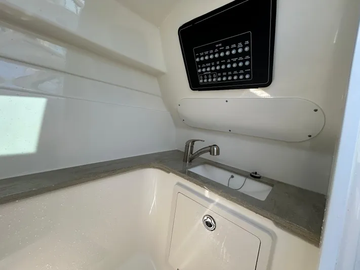  Yacht Photos Pics Interior view of 2021 Boston Whaler 320 Vantage boat, featuring a sink and control panel.