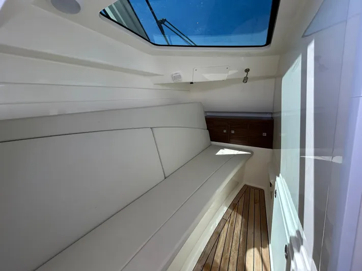  Yacht Photos Pics Interior cabin of 2021 Boston Whaler 320 Vantage with white seating and wooden flooring.