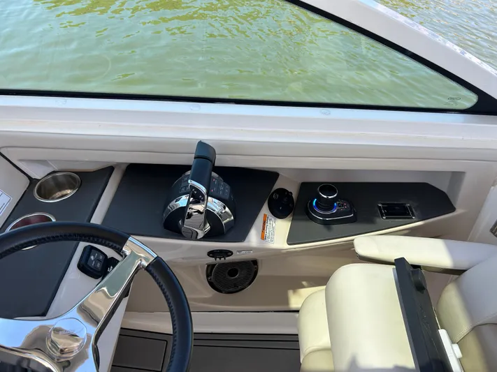 Yacht Photos Pics 2021 Boston Whaler 320 Vantage helm with steering wheel and controls, overlooking water.