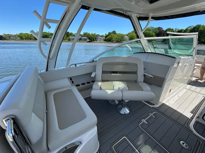  Yacht Photos Pics 2021 Boston Whaler 320 Vantage boat interior with seating, overlooking a serene water view.