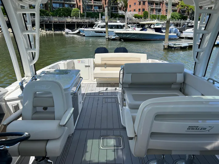  Yacht Photos Pics 2021 Boston Whaler 320 Vantage boat interior with seating, docked in a marina.