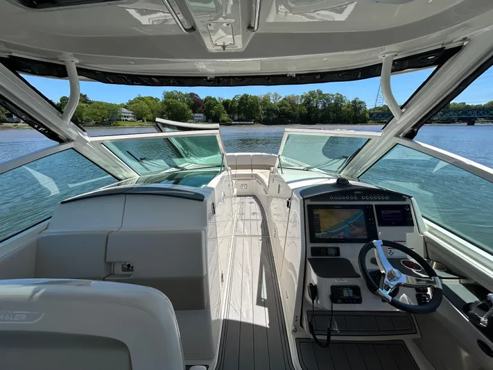  Yacht Photos Pics 2021 Boston Whaler 320 Vantage boat interior with steering console and water view.