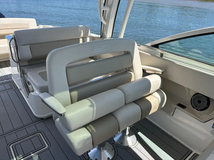  Yacht Photos Pics 2021 Boston Whaler 320 Vantage boat interior with cushioned seating and water view.
