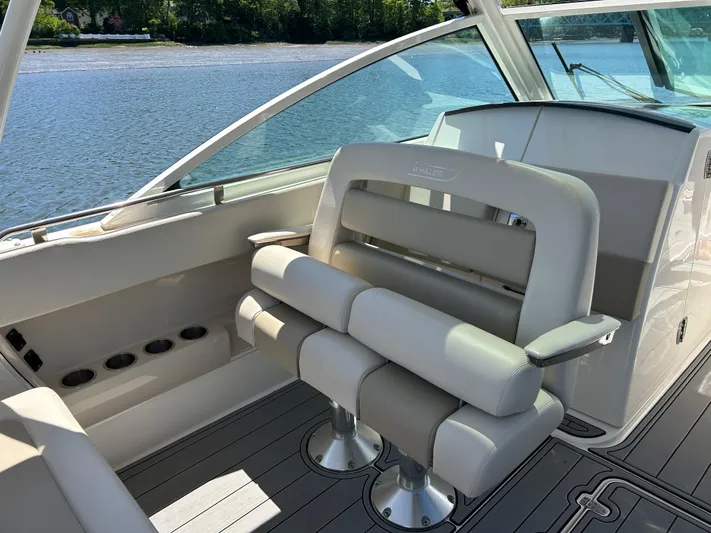  Yacht Photos Pics 2021 Boston Whaler 320 Vantage boat interior with cushioned seating and scenic water view.