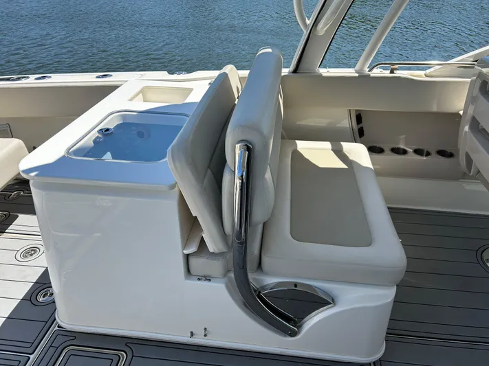  Yacht Photos Pics 2021 Boston Whaler 320 Vantage boat seating and console detail by the water.