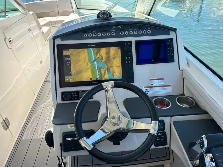  Yacht Photos Pics 2021 Boston Whaler 320 Vantage helm with navigation screens and steering wheel.